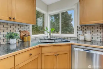Kitchen has new counter tops and new fabulous porcelain backsplash that ties it all together with the original maple cabinetry