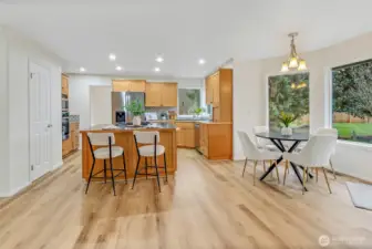 Beautiful new stainmaster Golden Belle Hickory LVP flooring throughout the main level. Kitchen is spacious with an eating bar and a separate dinette area with large windows to look out to the wonderful backyard . Door to the left is the walk in pantry