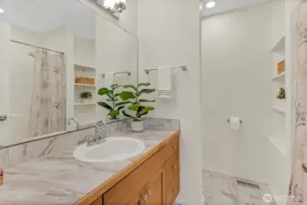 This is the main hall bathroom upstairs which includes new tile floors and backsplash,new counter top, new lighting and a new toilet as well!