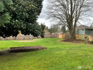 More viiews of how spacious this 2/3 of an acre lot is. There was an above ground pool in that circle area to the back. Along that back fence line is a community drainfield easement but it does not interfere with the play area of this yard at all!