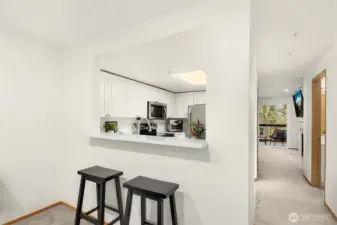 Barstool seating to enjoy company from the dining into the kitchen.