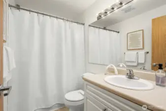 Second full bathroom upstairs with tub and plenty of storage.