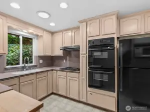 The thoughtfully designed kitchen features solid wood cabinets.