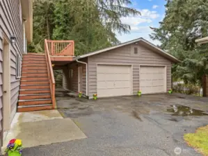 The side of the house has a detached garage currently set up for a woodshop.