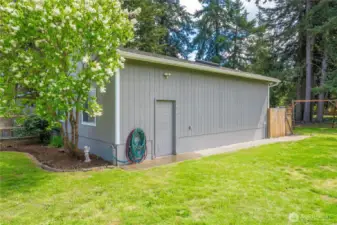 Side entrance to the 832 sqft garage with a shop