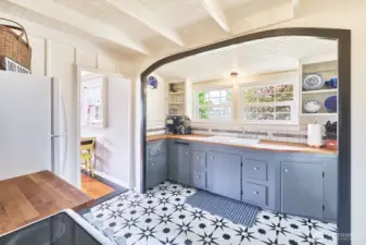 Ship-shape kitchen has butcher block counters and a classic East-facing farm style sink