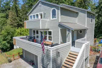 Main level entrance, entertainers deck, and private primary balcony.