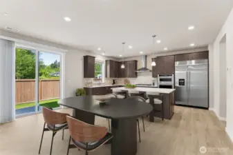 Spacious kitchen and informal dining area - virtually staged.