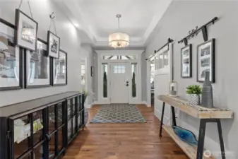 Welcoming entry hallway with the office and guest bedroom 1 located at front of home