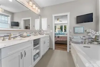 Primary ensuite bathroom with radiant heated floors, epoxy grouted tile, quartz countertops.