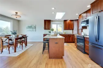 Open floor plan with kitchen opening to dining and living room.  Cabinets are cherry, counters are granite.  Appliances are new since 2019.