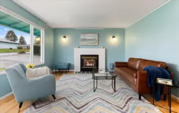 Hardwood floors, updated modern lighting, and yummy color bring this living room to life.