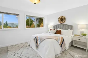 Upstairs primary bedroom is light and bright.