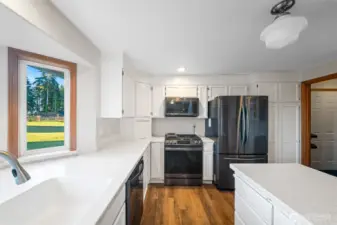 The cabinets tops were extended to the ceiling to eliminate any cleaning trouble. Nice looking, newer appliances