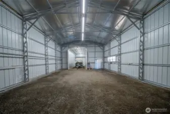 You can store a LOT of toys in this space. It also has an RV clean out and telephone. This rear bump out measures approximately 12'x24' and it has another roll up door, so you could drive something through the whole hangar.