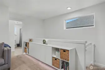 View of your upstairs landing/loft and amazing built-in storage. Kids/guest full bath to your left.