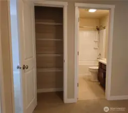 The linen closet has ample storage.