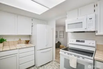 kitchen opening to casual dining area & den w/ backyard access