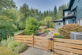 A charming fenced-in area on the side of the house adds both functionality and charm to the property. Perfect for pets, gardening, or a safe play space for children, it provides a secure and private outdoor retreat while still blending seamlessly with the surrounding acreage. Mature landscaping and open space create a picturesque setting, enhancing the home’s sense of privacy and tranquility.