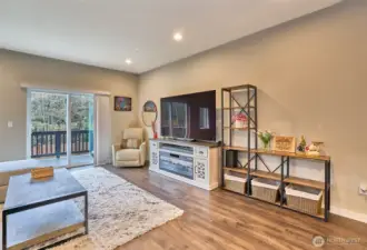 Spacious, living area, door to deck. Lots of natural light.