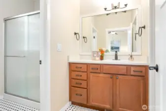 Ensuite has large walk-in shower in separate room from vanity. Pretty checkered ceramic tile flooring