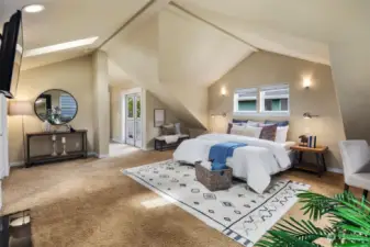 The primary bedroom is a true retreat with vaulted ceilings and quick access to the deck.