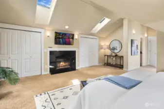 His 'n her closets and skylights add to the appeal of this bedroom.