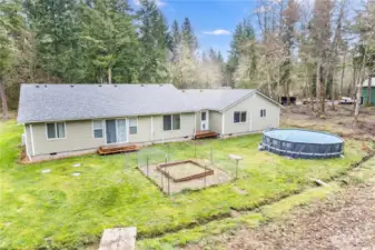 Main home has to back decks, enclosed garden space and above ground pool. The seasonal creek separates the back yard from other parts of the property