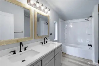 Updated primary bathroom with double sinks and shower tub surround