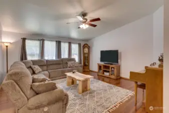 The large living room has vaulted ceilings, windows and sliding door leading to back yard.