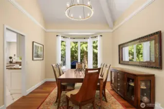 This home's formal dining room offers views of the large woodsy backyard.