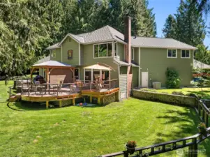 This home's expansive parklike setting creates a peaceful atmosphere, which is wonderful for outdoor enthusiasts and nature lovers.