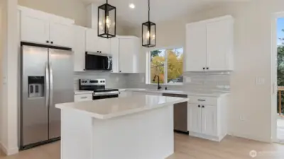 Stainless appliances including the fridge.