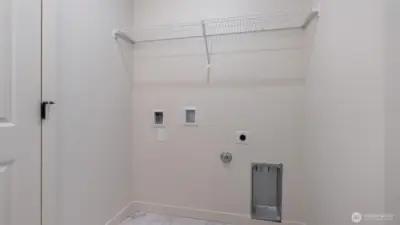 Laundry room has tile flooring.