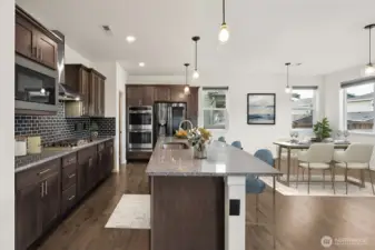 Fabulous kitchen/ dining open to the great room- Virtually staged