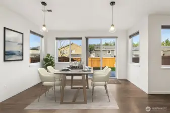 Tons of natural light in this open dining area. Virtually staged