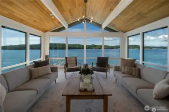 Centered on breathtaking west-facing views, this living space brings the outdoors in with walls of glass framing ferries, boats, and Orcas Island’s iconic island scenery.