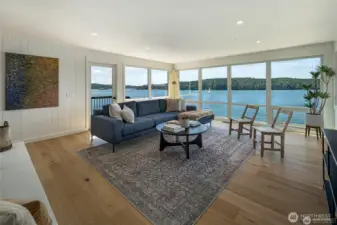 The main living area features wraparound windows that immerse you in Orcas Island’s waterfront scenery, from sailboats to sunset reflections. An open-concept floor plan and designer furnishings create a calm, luxurious coastal atmosphere.