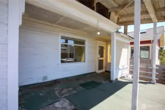 This door is from the enclosed porch leading to the front deck. The window here is from the kitchen area.