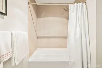 Custom tile surrounds the tub/shower.