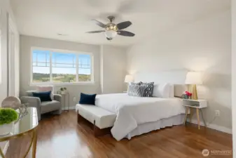 Spacious primary bedroom with nice view