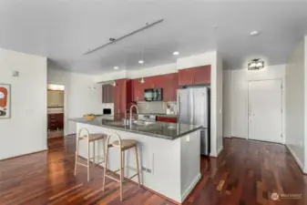 Large kitchen island with storage and small office nook. This condo is Virtual Staged.