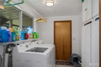 The laundry room connects the kitchen to the garage and also has abundant storage.
