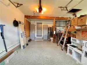 This garage floor has a custom epoxy coating on it. This home also comes with a 50 amp electric car charger. 30 amp exterior RV hookup. Workshop in upper right corner. Garage fridge does NOT convey, but it does offer water hookup behind it.