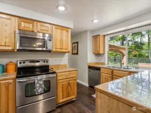 The kitchen flows from the dining to the family room. Large window overlooks the back yard. SS appliances.