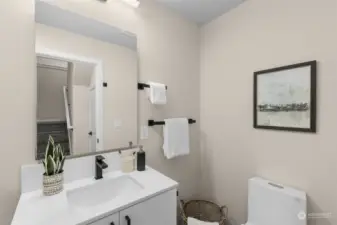 This chic and practical bathroom has matte black fixtures, open shelving, and modern lighting. It's the space that makes getting ready for the day feel like a mini spa moment.