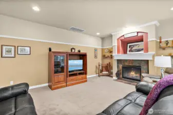 Cozy family room with gas fireplace and brand new carpet.