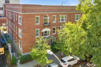 Charming brick exterior with garden surroundings, just steps from UW, cafés, and Light Rail.