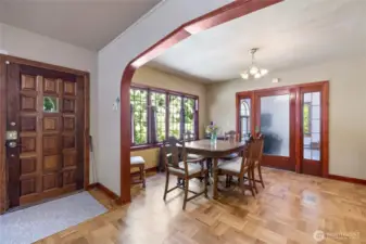 Gothic arches with amazing trimwork lead through the formal dining room.