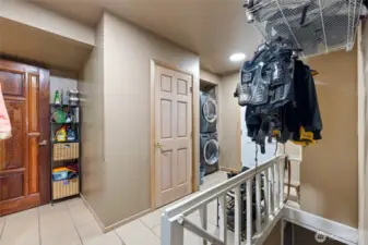 The utility space offers PLENTY of storage areas, access to the basement garage, and a powder room!